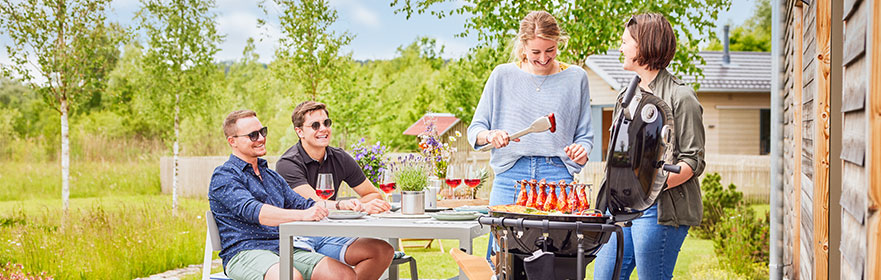 Friends barbecue together on charcoal kettle grill AIR F60