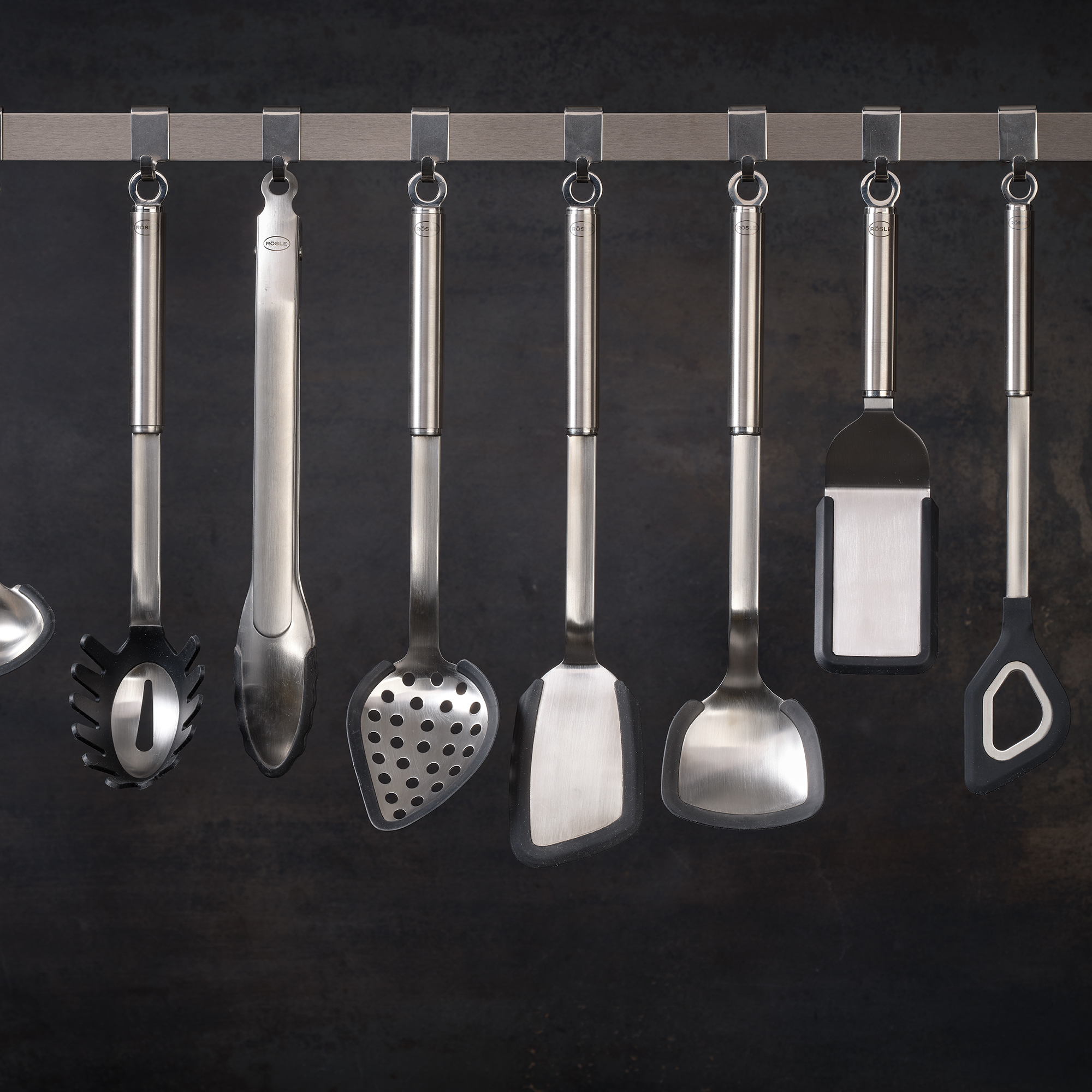 RÖSLE gourmet tongs made from silicone Gourmet tongs made of silicone, 23 cm long, hanging on a bar with other kitchen tools.