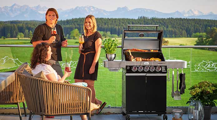 Friends barbecue together on the terrace