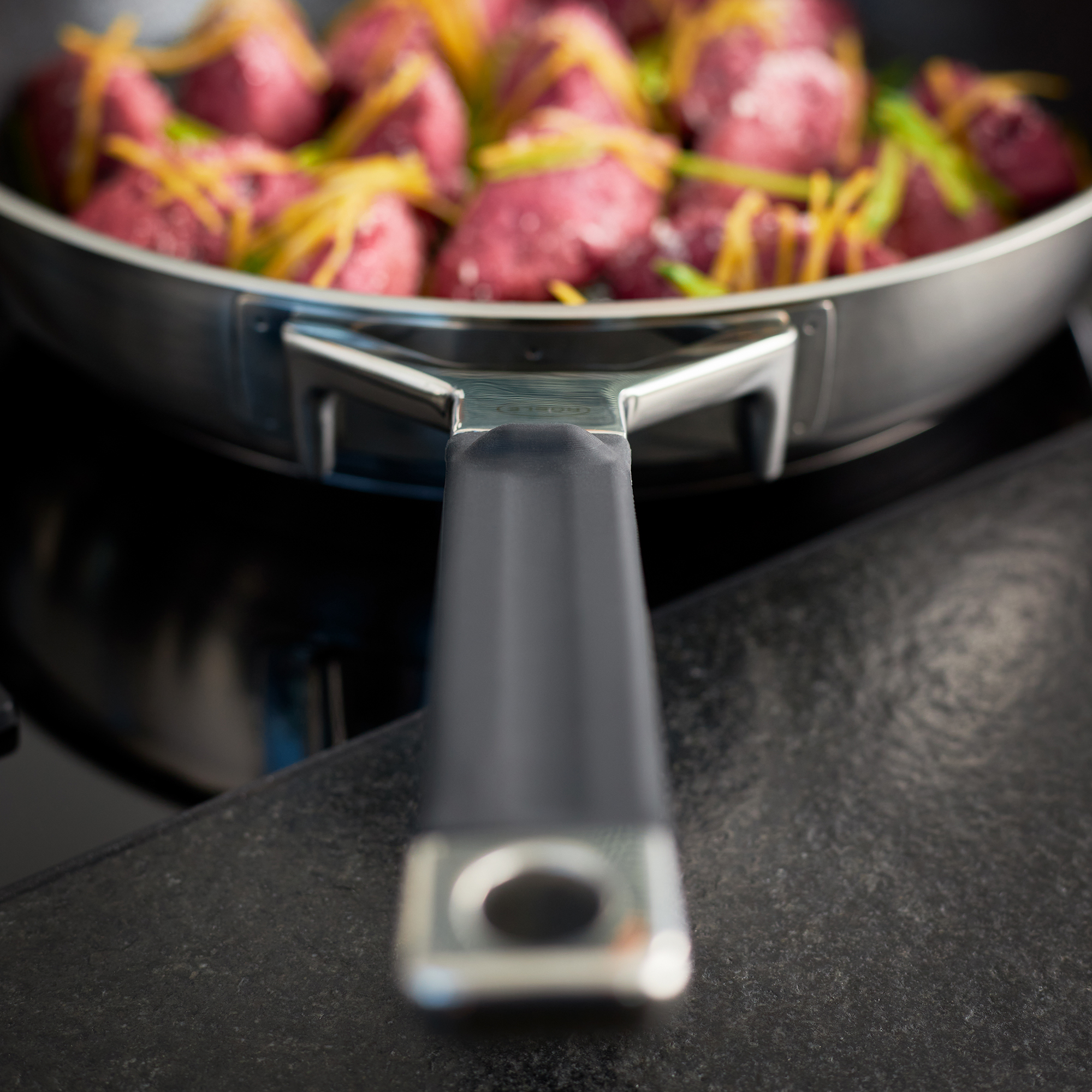 RÖSLE frying pan 28 cm ProResist Silence Pro Stainless steel frying pan with black handle, filled with raw minced meat and vegetables.