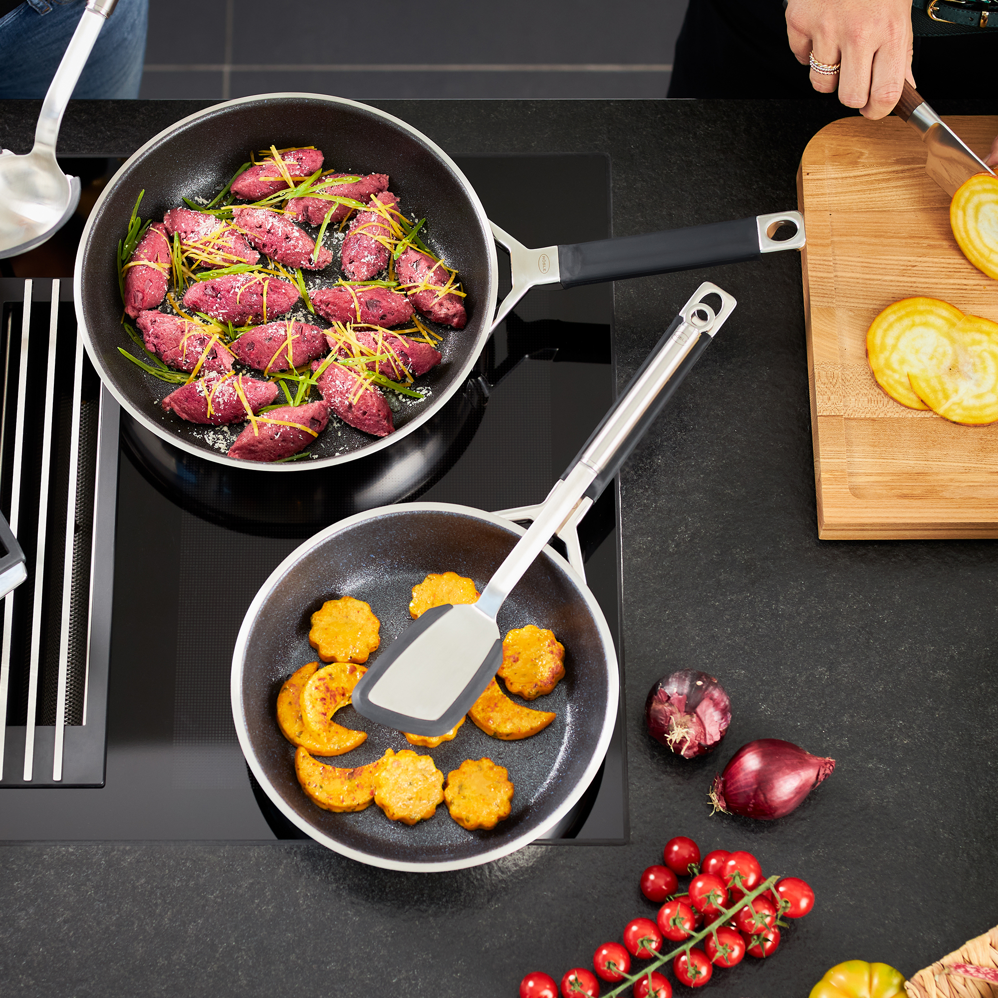RÖSLE frying pan with purple potatoes and pumpkin Frying pan 28 cm with purple potatoes and a small pan with pieces of pumpkin, on a modern...