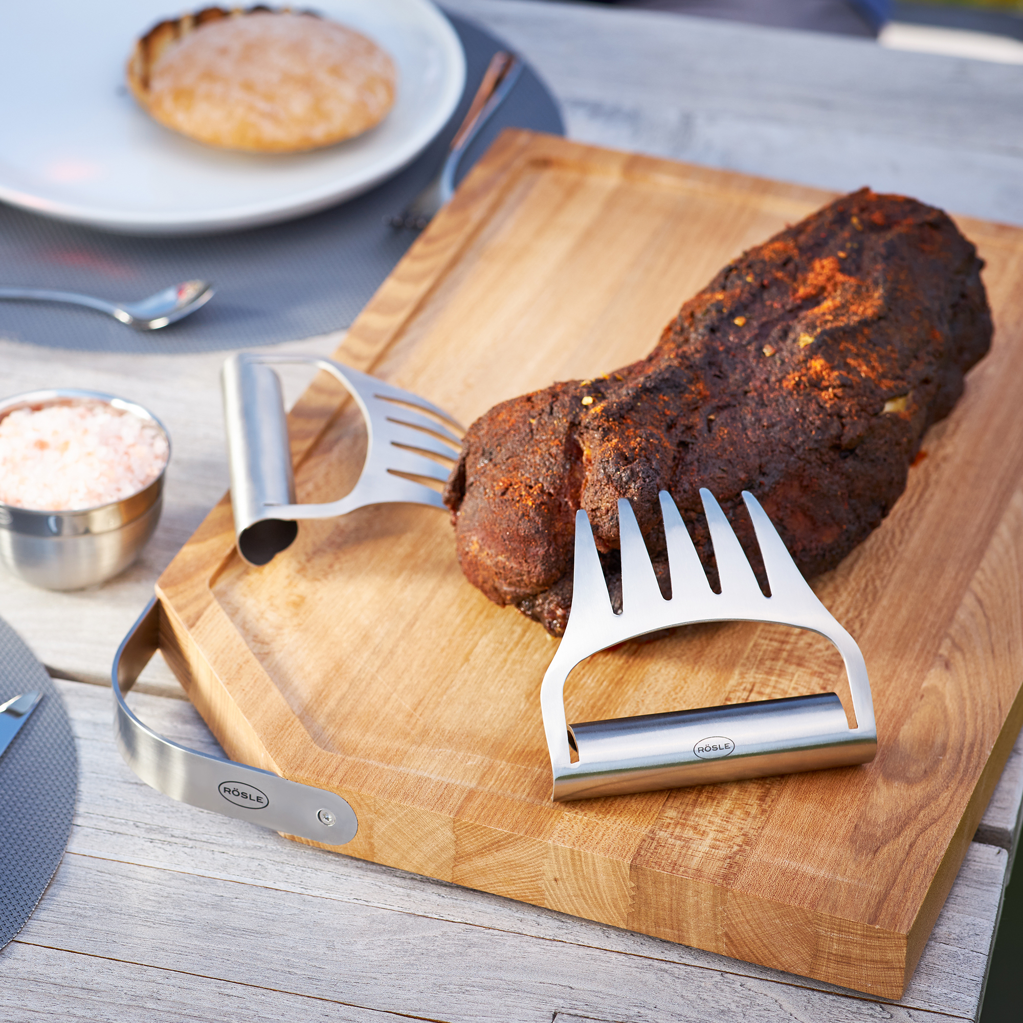 Stainless steel pulled pork forks from RÖSLE Stainless steel pulled pork forks on a wooden board with a piece of pulled pork and a bowl...