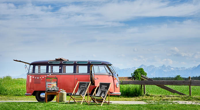 Rösle deck chairs in front of a mountain backdrop and a VW bus