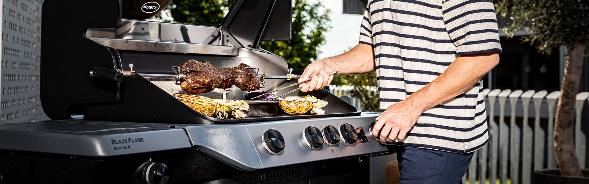 RÖSLE Blaze Flame Grill im Einsatz Blaze Flame Grill mit Fleisch und Gemüse auf dem Grillrost, Person grillt im Freien.