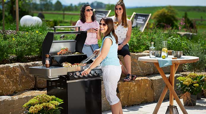 Friends barbecue together on the terrace 