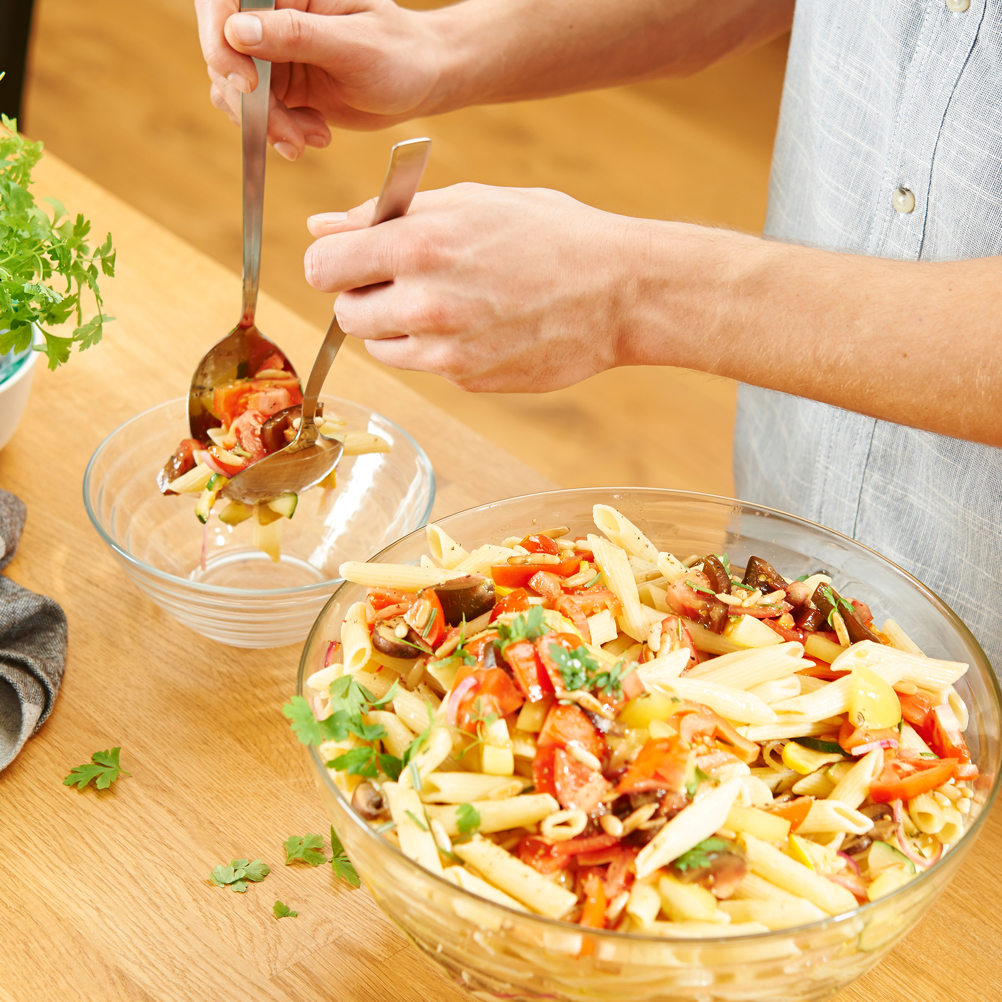RÖSLE salad servers in action Stainless steel salad servers, 28 cm, used for serving pasta salad.