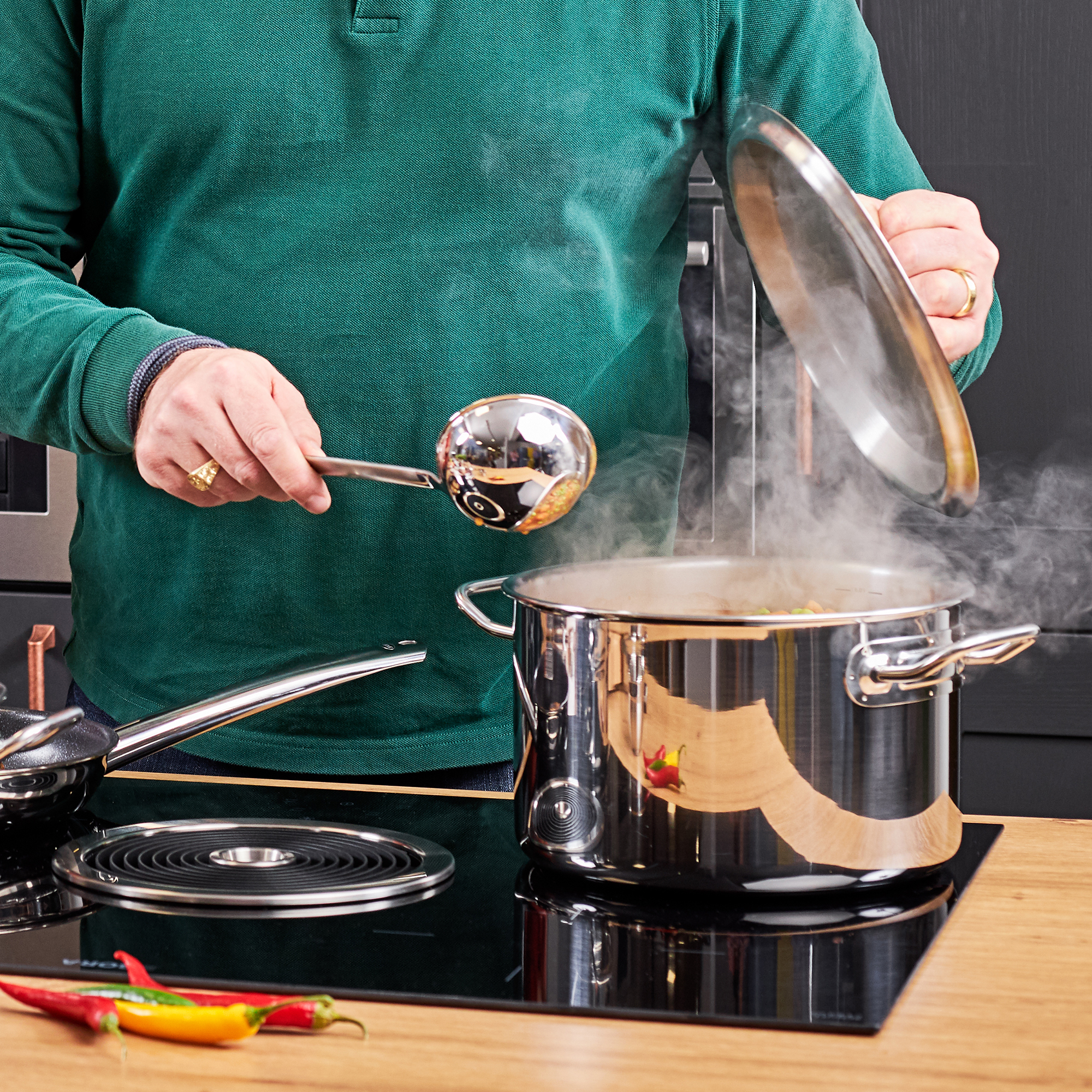 RÖSLE ladle in use Stainless steel ladle, 10 cm, is used to ladle hot soup from a steaming pot.