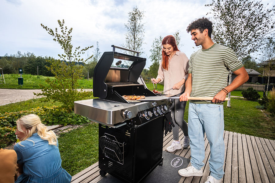 Returns Friends grill pizza together on a pizza stone
