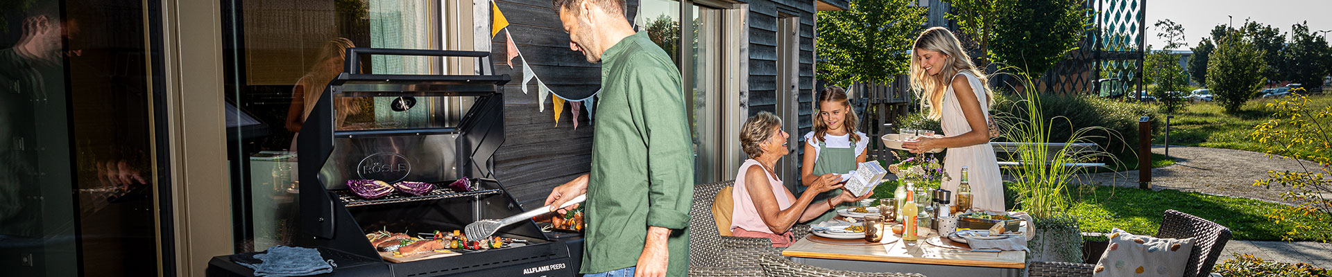 Catalogues Family barbecues together on the terrace.