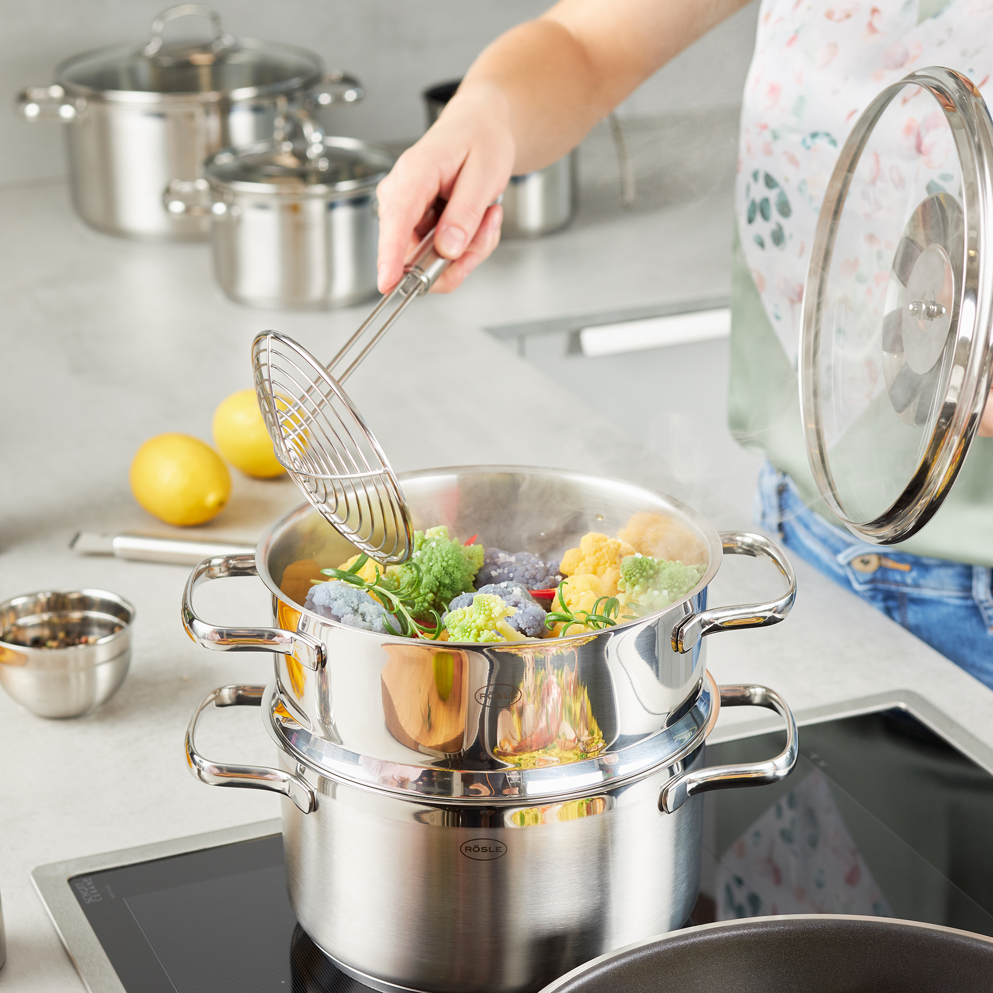 RÖSLE colander in action Stainless steel colander spoon, 12 cm, is used to lift vegetables out of a cooking pot.