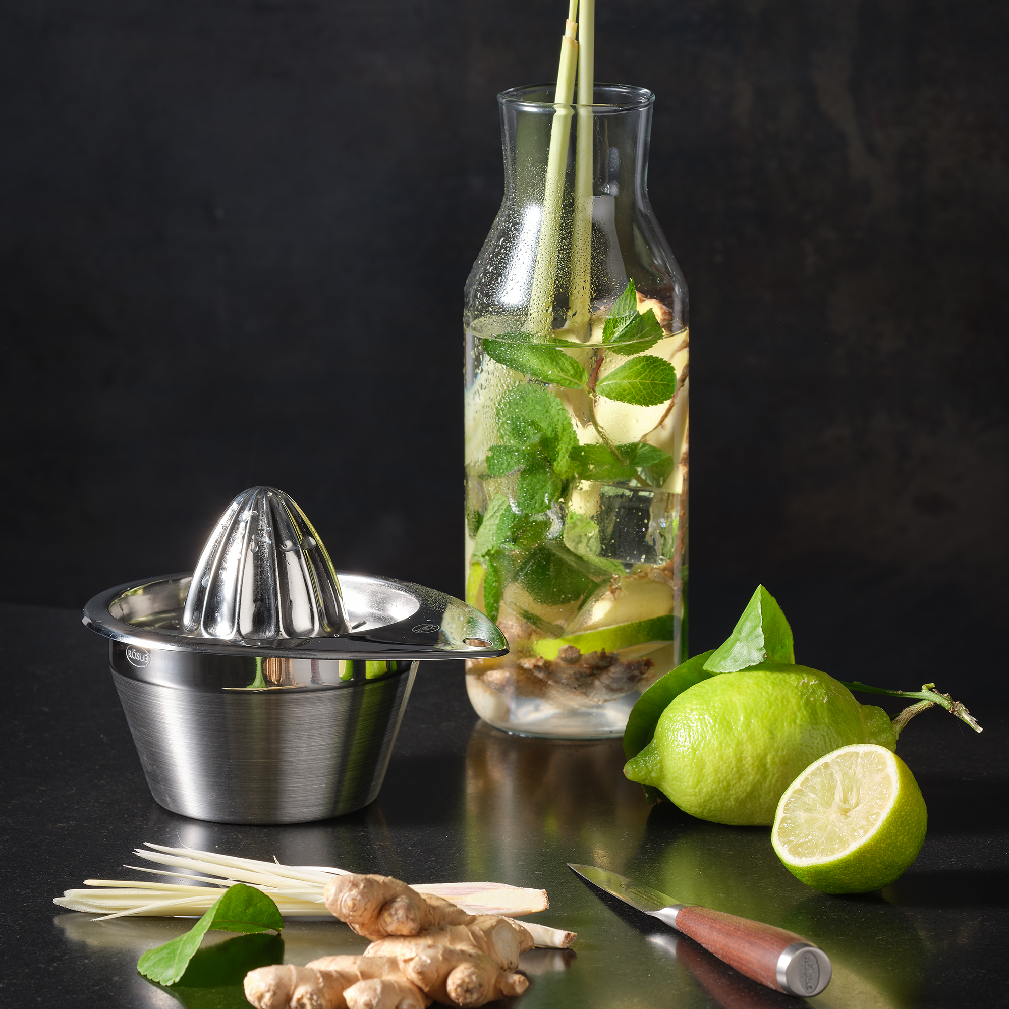 RÖSLE lemon squeezer and fresh ingredients Stainless steel lemon squeezer surrounded by fresh ingredients such as limes, ginger and lemongrass...