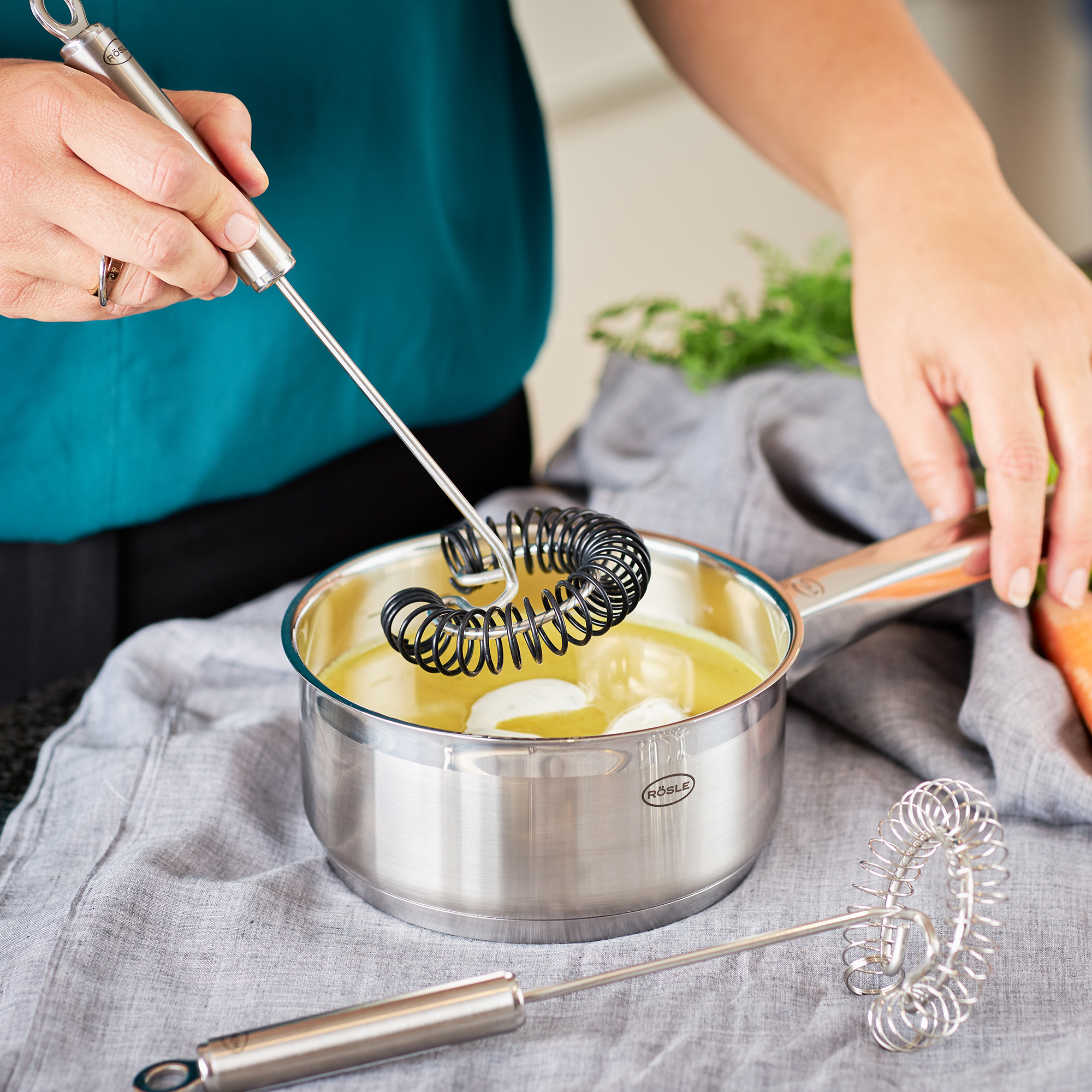 RÖSLE spiral broom in action Silicone spiral whisk, 27 cm, is used for stirring in a pot.