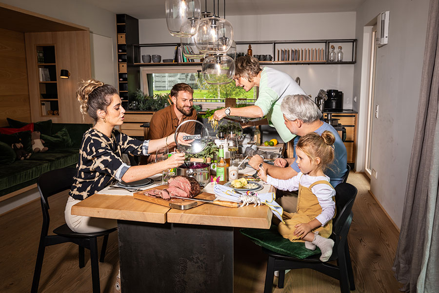 Contact us Family eating a roast together at the table.