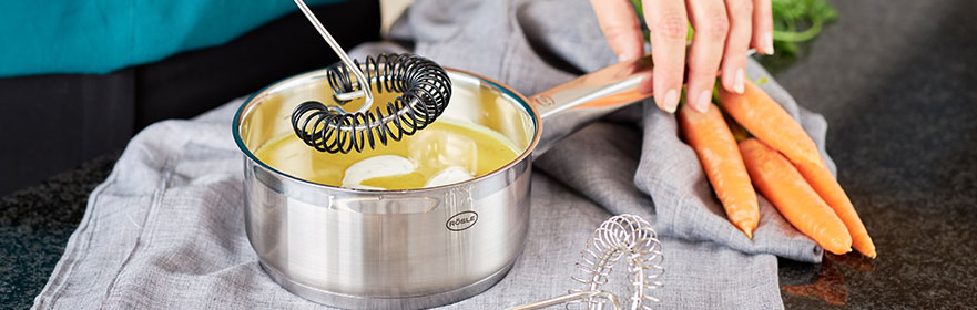 Stirring sauce with the spiral whisk Silicone in the saucepan Cham