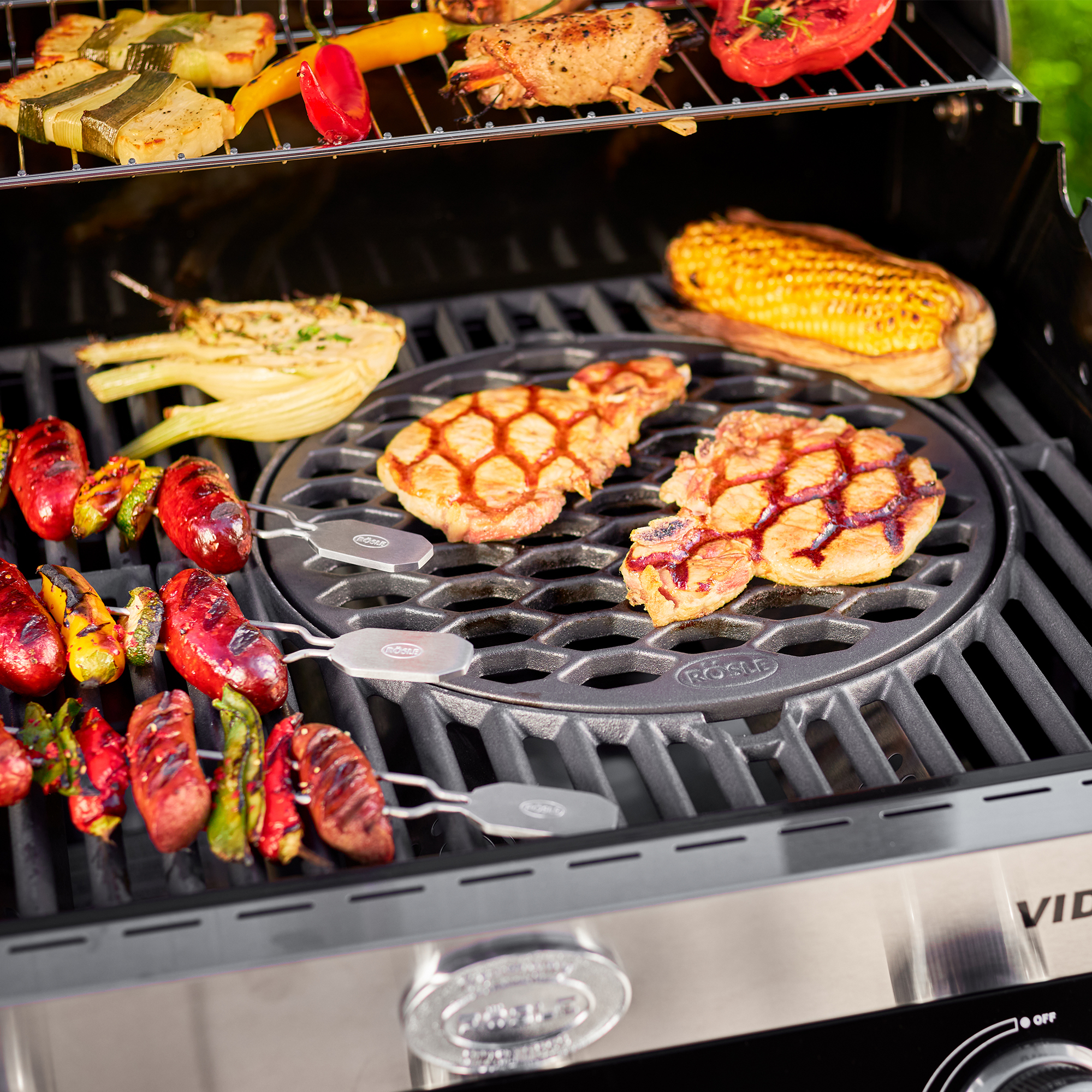 RÖSLE Grillrost Vario 30 cm Grillrost Vario mit Wabenstruktur, auf dem gegrilltes Gemüse und Fleischstücke liegen.