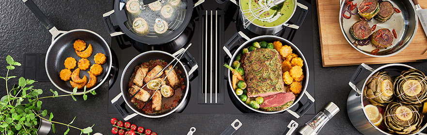 SILENCE PRO cookware series with kitchen utensils and food