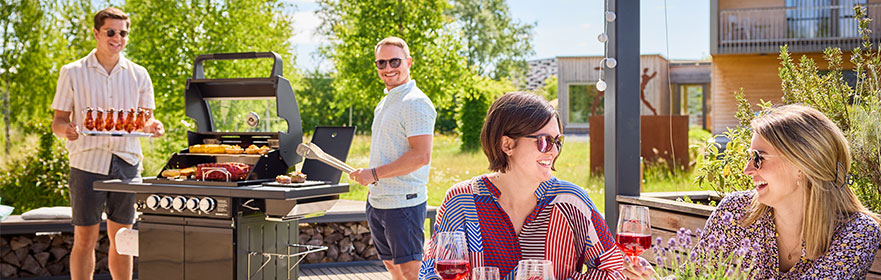 Freunde grillen zusammen und lachen