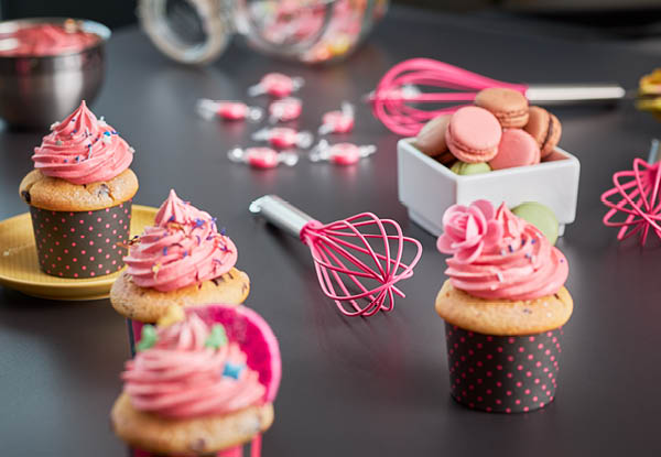 whisk Pink Charity pink cupcakes next to whisk Pink Charity