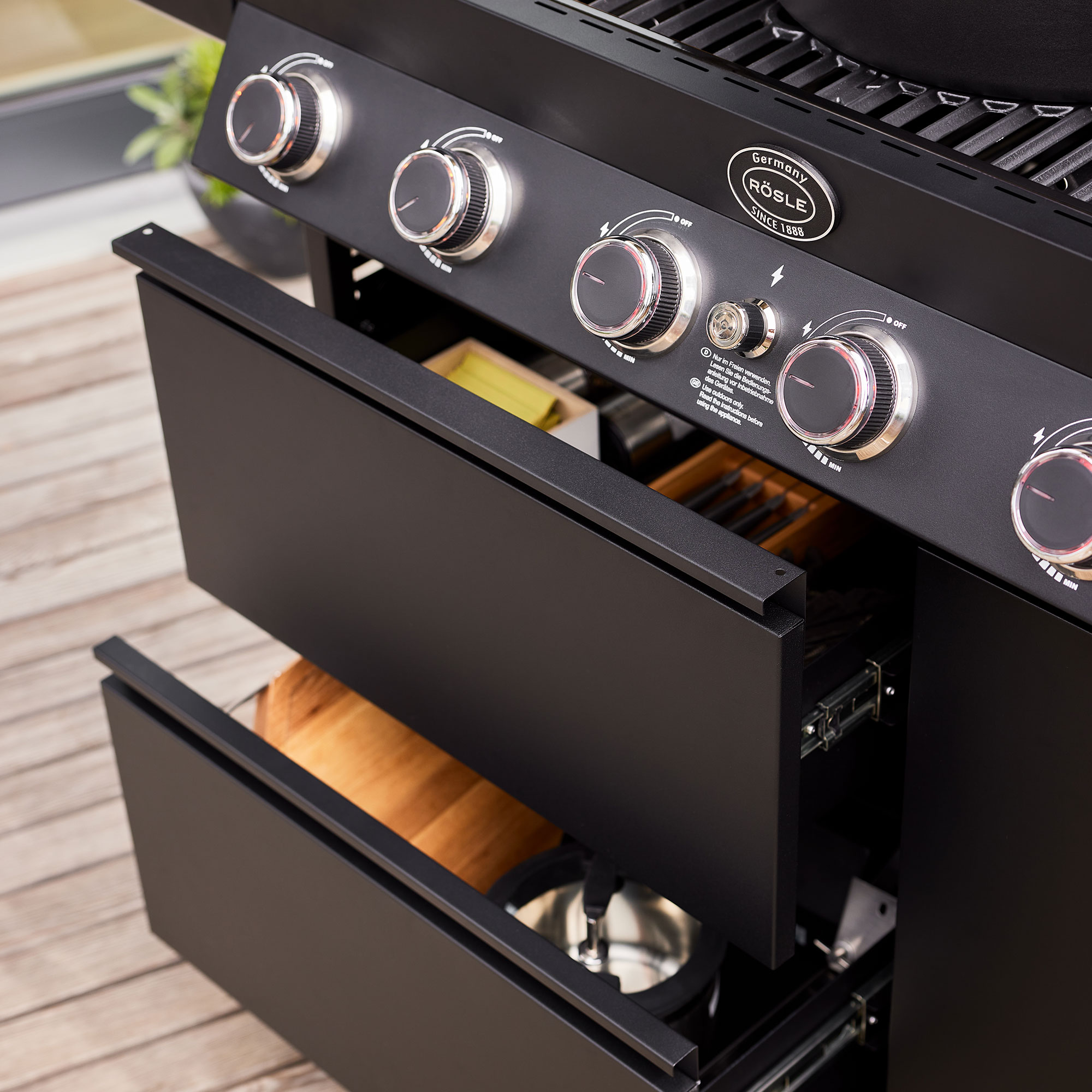 RÖSLE Gasgrill Videro G6-S PRO mit Zubehör Gasgrill Videro G6-S PRO mit geöffneten Schubladen, die Grillzubehör und Utensilien zeigen.