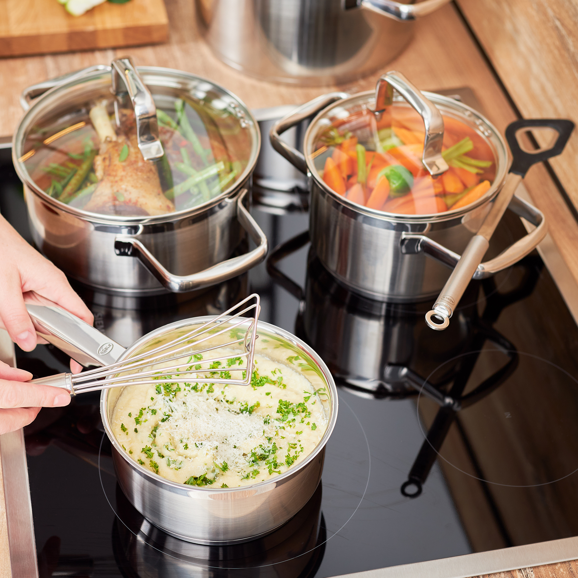 RÖSLE saucepan 16 cm on induction hob Cooking pot, 16 cm, made of stainless steel, with a hand mixer, on an induction hob, surrounded...