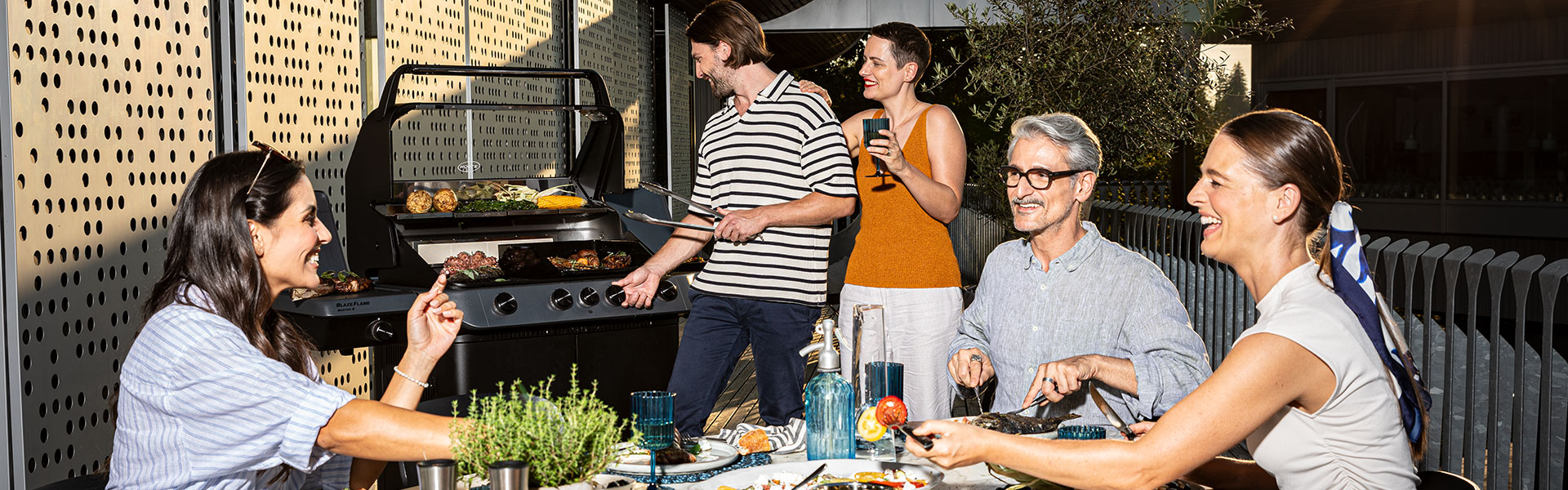 5 friends barbecue together on the terrace