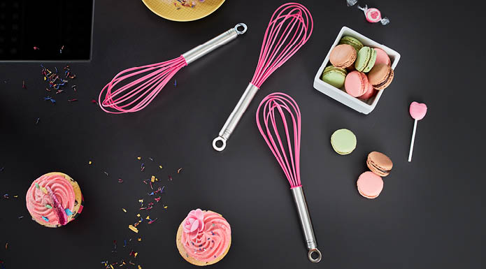 Whisk Pink Charity and Macarons on a Table