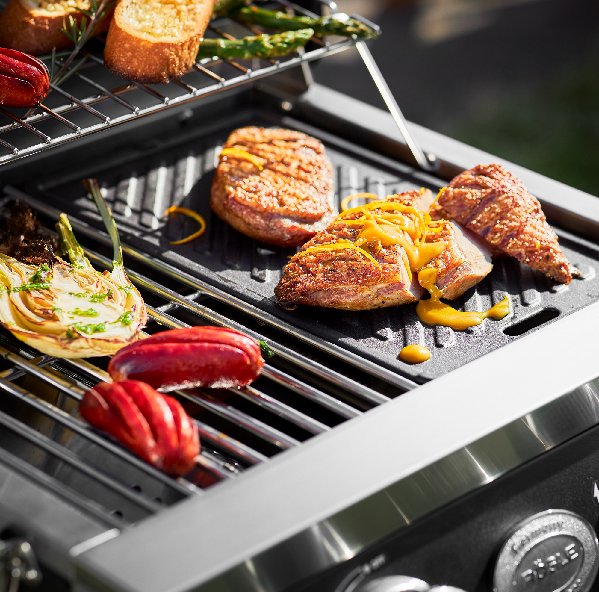 RÖSLE Gasgrill Videro G2-P mit Grillgut Gasgrill Videro G2-P mit gegrilltem Fleisch, Paprika und Zwiebel auf dem Grillrost.