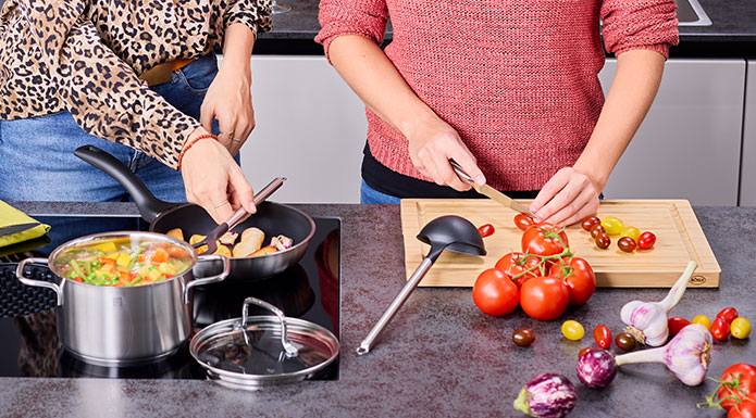 Zwei Frauen kochen gemeinsam in den Töpfen und mit den Messern der Serie Basic Line