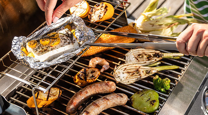 Elektrogrill E2-P Feta in Alufolie auf dem Warmhalterost des Elektrogrills