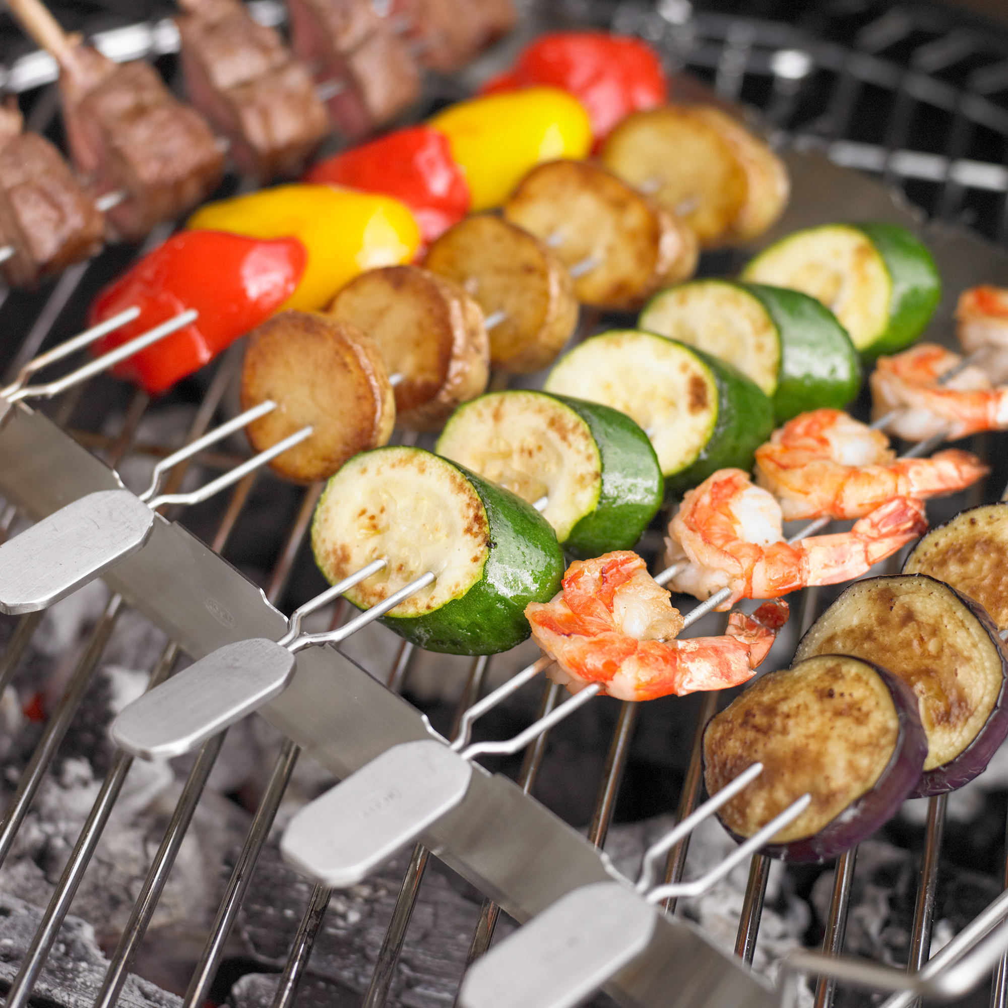 Barbecue skewers set of 4 from RÖSLE Grill skewers with vegetables, prawns and meat on a grill rack.