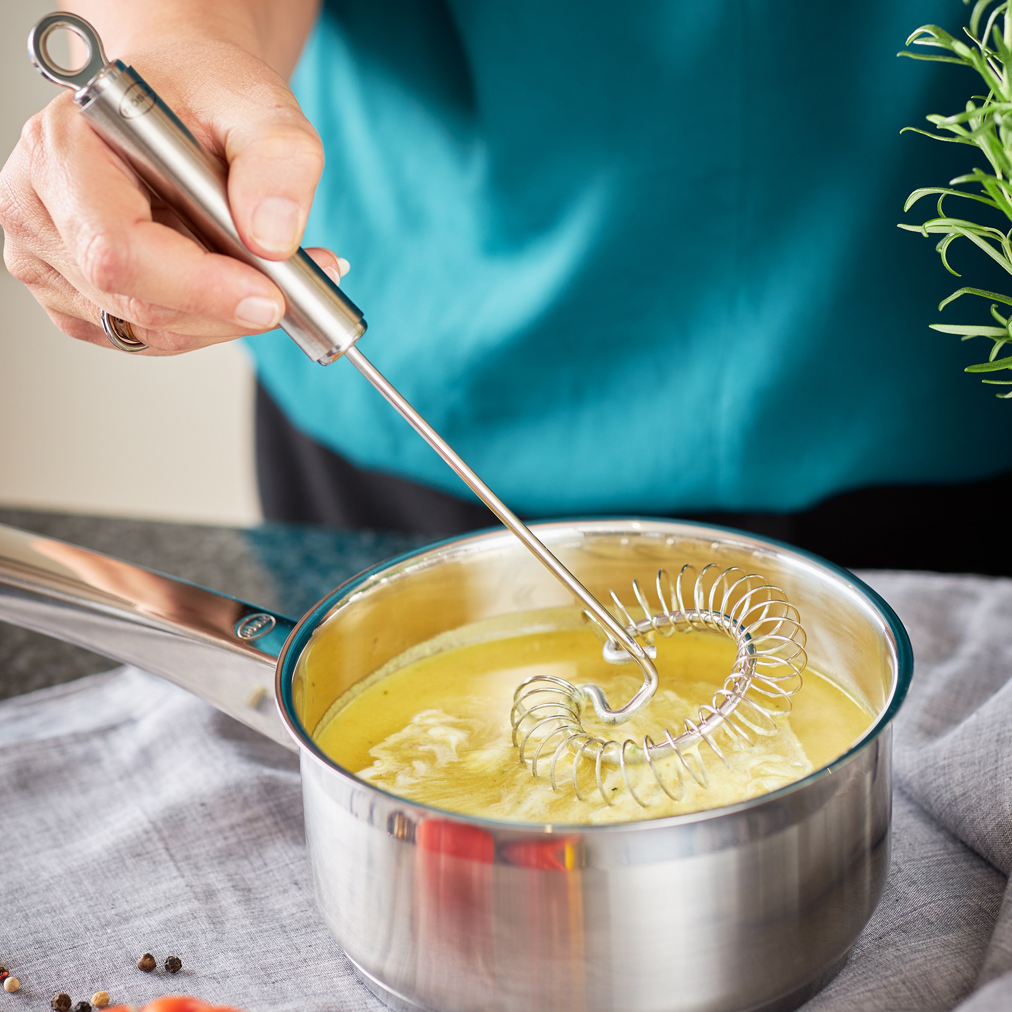RÖSLE spiral broom in action Stainless steel spiral whisk, 22 cm, is used for stirring in a pot.